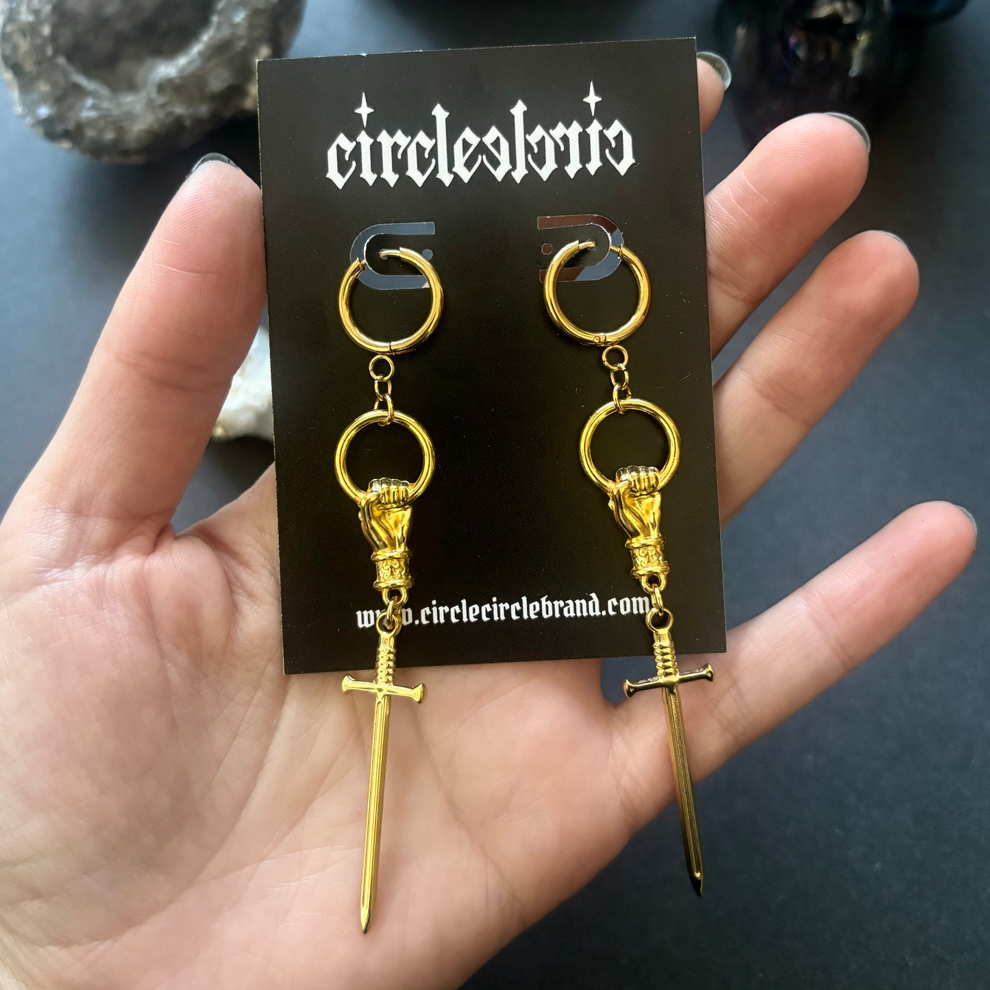 Hand and Sword gold dangle earrings