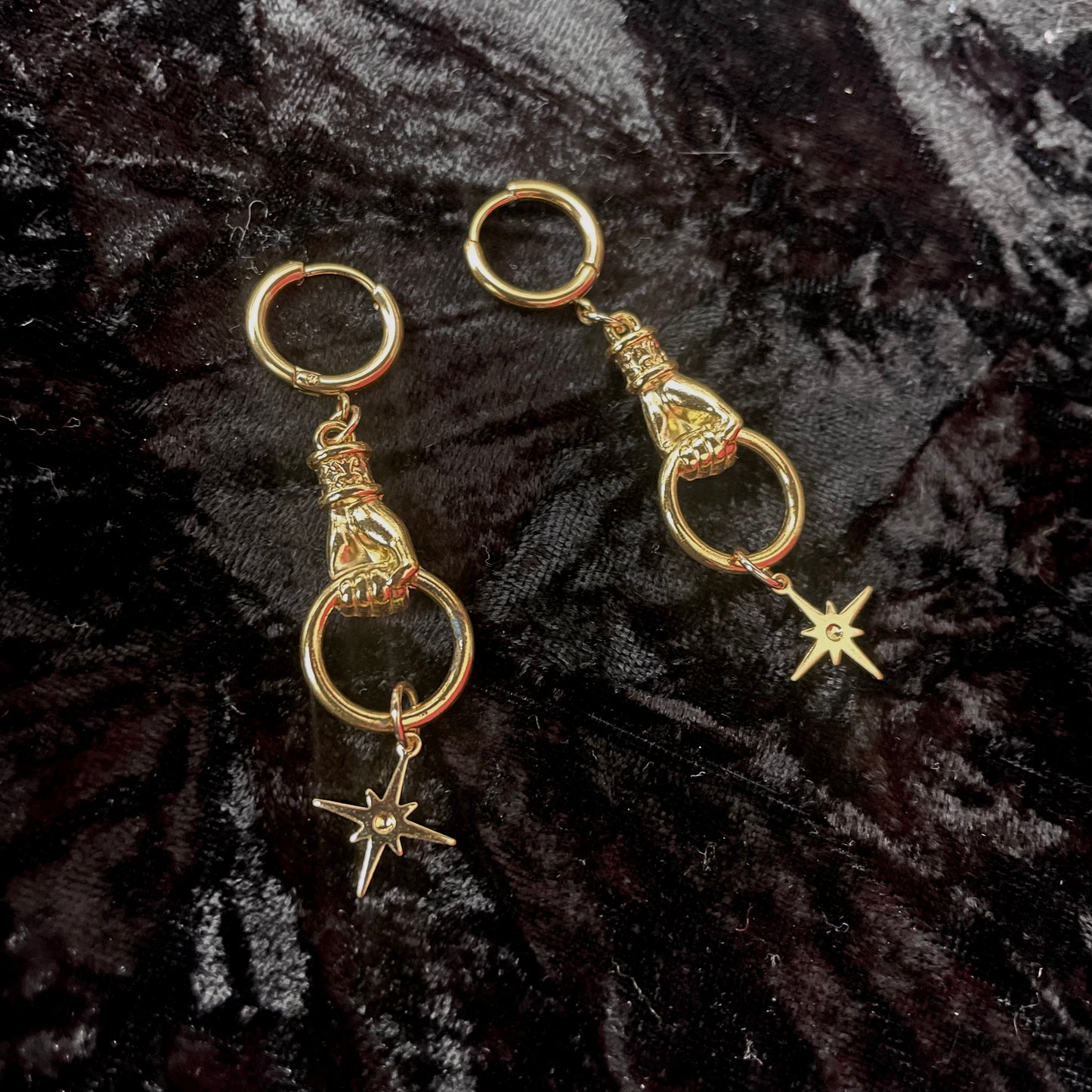 Gold dangly hand and star hoop earrings