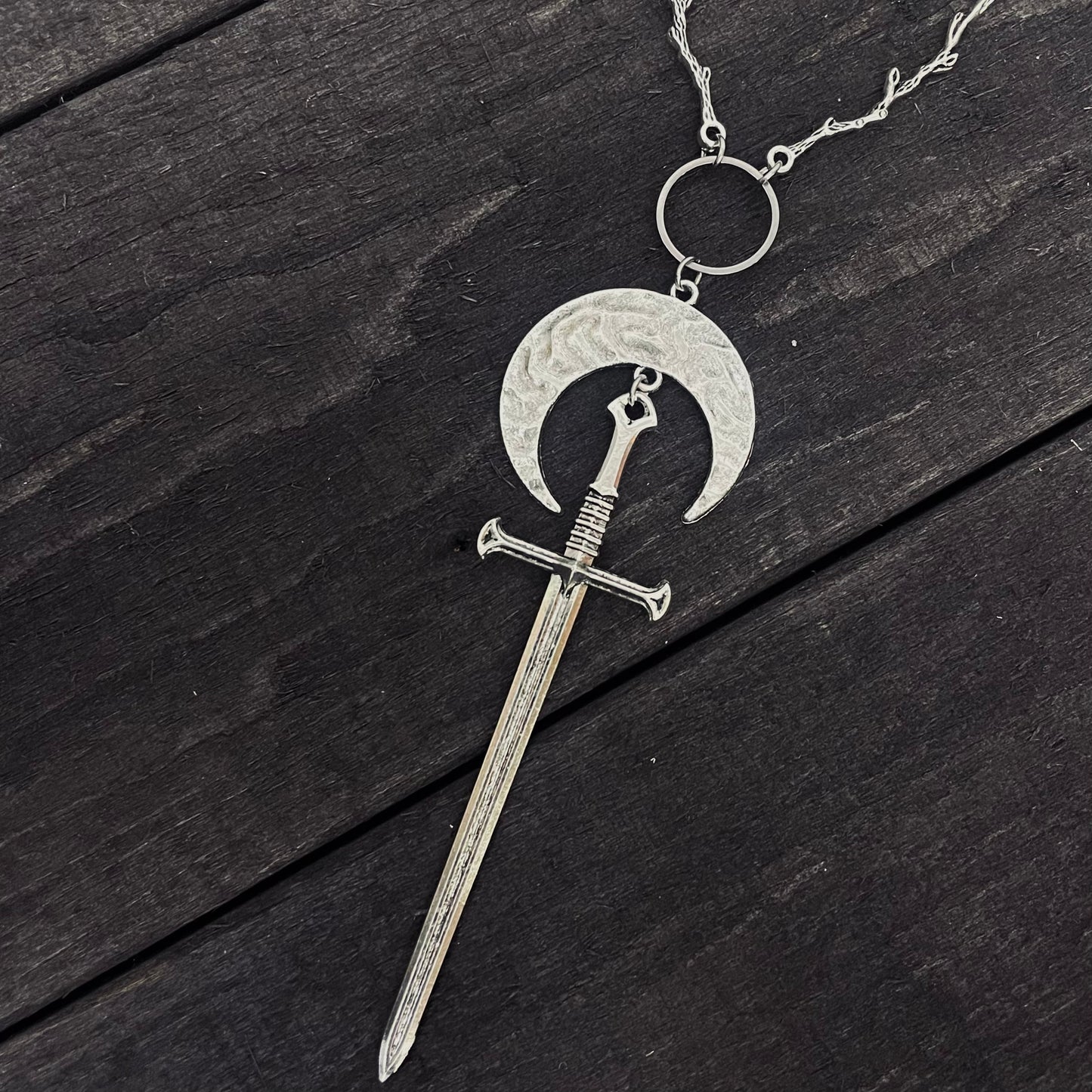 Sword and moon necklace with branch details