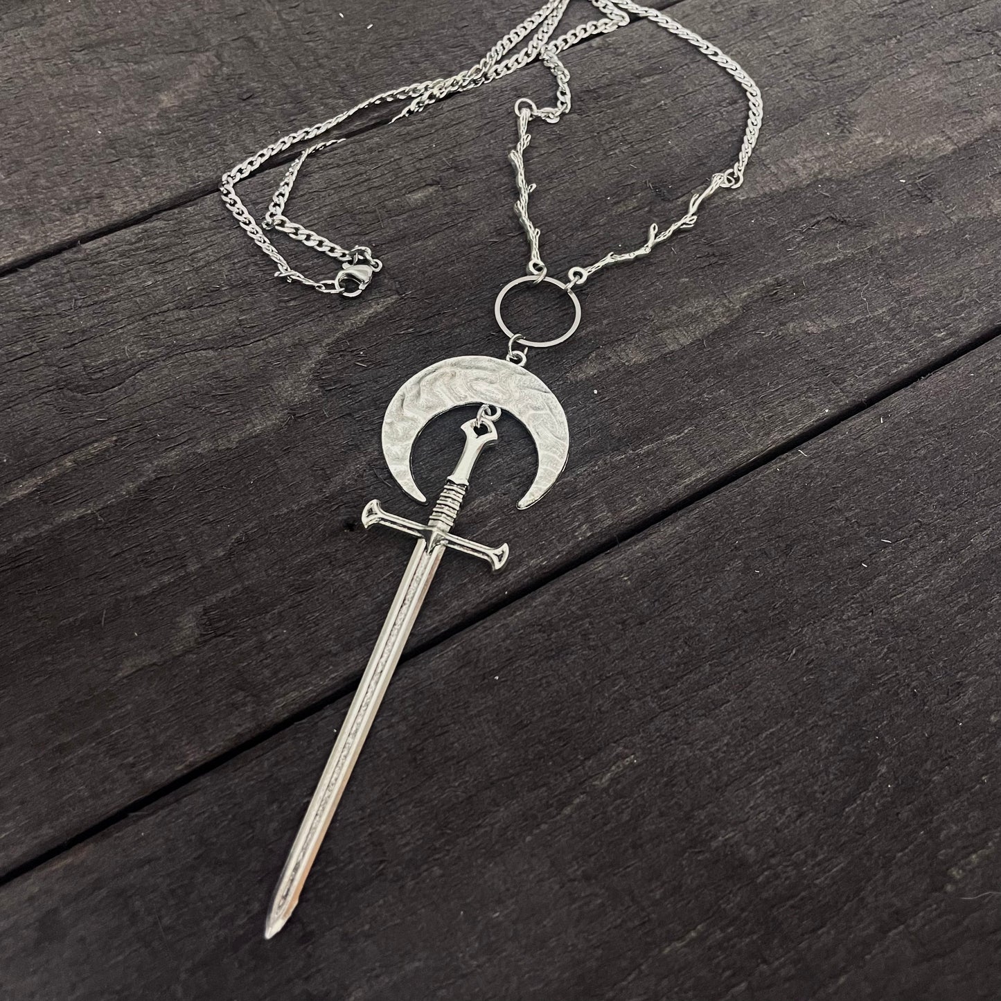 Sword and moon necklace with branch details